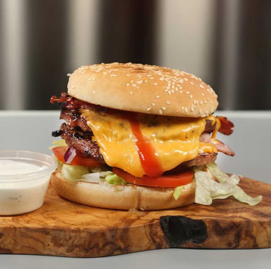 Double cheeseburger with bacon, ketchup and fresh vegetables in Rosyth.